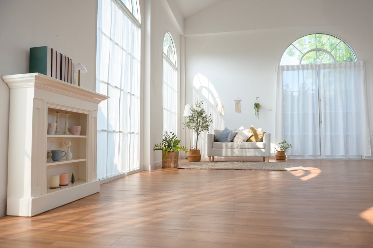 Bright, beautifully clean living room with large windows and soft decor